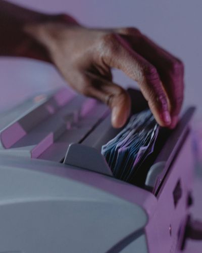 Financial analyst working on detailed discounted cash flow valuation model with spreadsheets